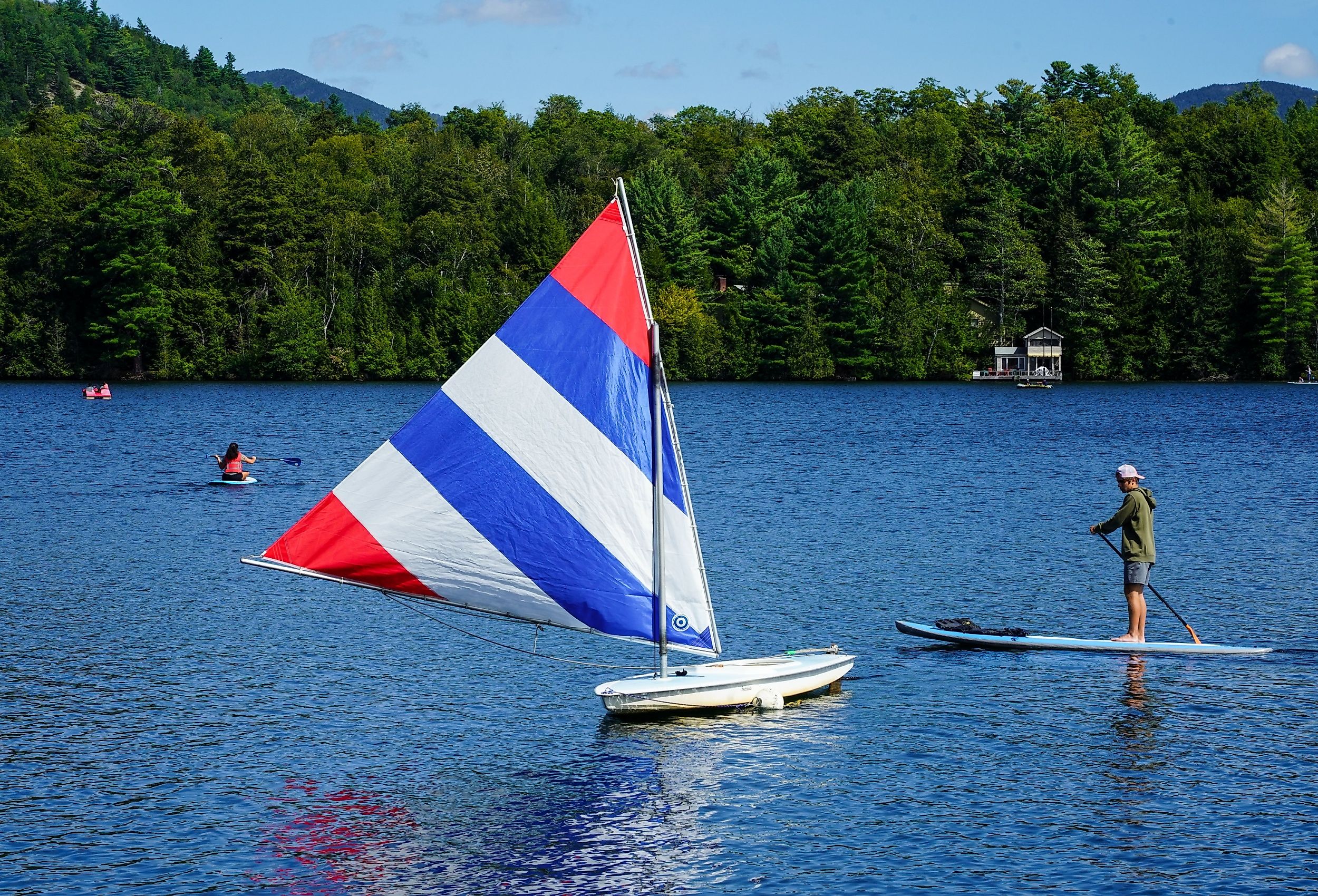 Water boarder enjoys summer day on Mirror Lake in Lake Placid, New York. Image credit Leonard Zhukovsky via Shutterstock